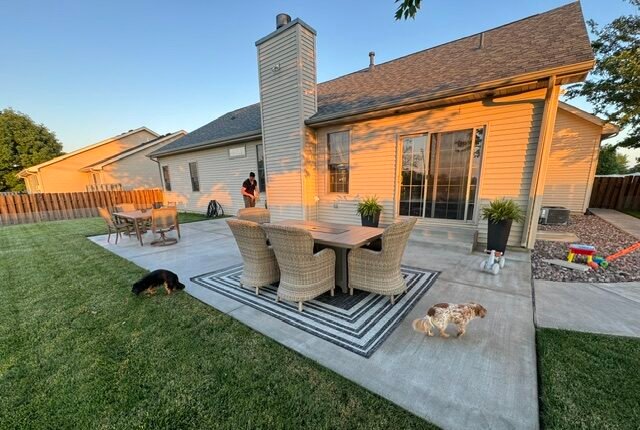 Large concrete backyard patio we chose to invest in instead of rebuilding our deck